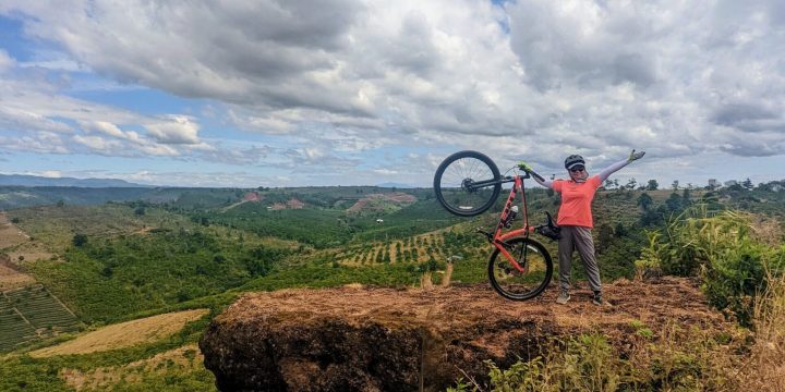 Cyclist and Bike on Edge of Cliff