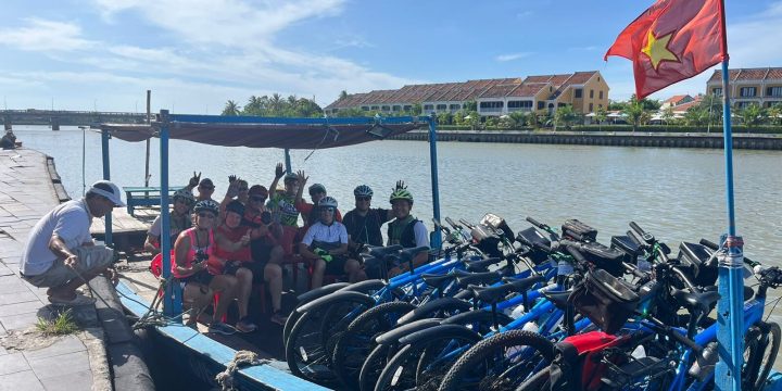 Cyclist and bikes loaded up for river crossing